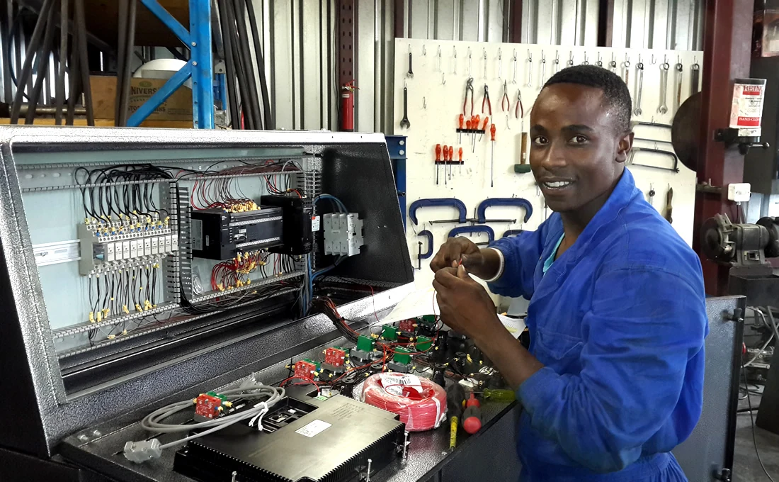 Technician building and wiring an industrial control board
