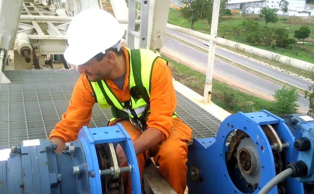 Technician inspecting industrial equipment on site