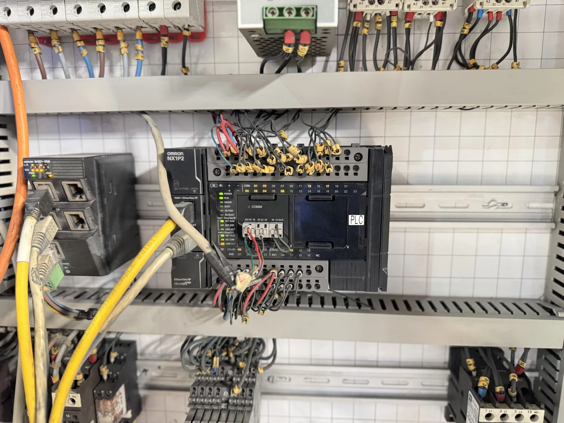 PLC and industrial network-control hardware inside a machine cabinet